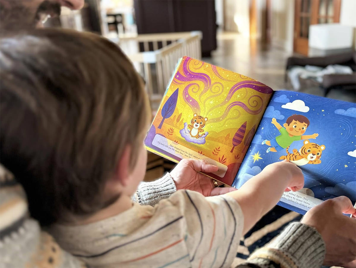 A child reading their personalized Little Hero Labs storybook